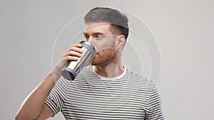 Man with thermo cup or tumbler for hot drinks