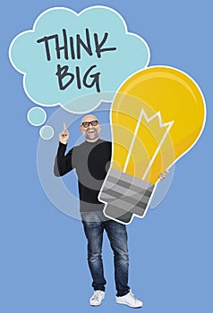 Man with Think big ideas holding a light bulb icon