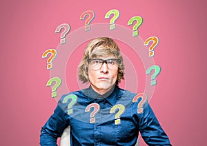 Man thinking with colorful funky question marks