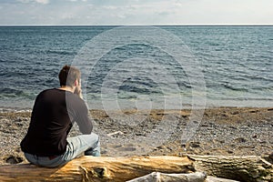 Man thinking on a log