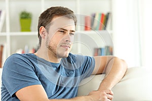 Man thinking looking away at home photo