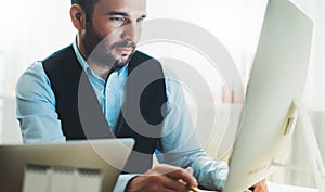 Man thinking looking in monitor computer at home workplace. bearded businessman working at social distance, finance consultant
