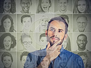 Man thinking looking up at group of multicultural happy people