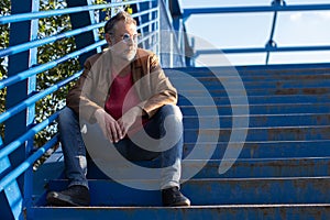 man thinking and sitting on stairs