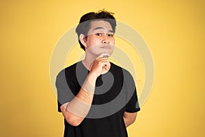 man thinking something and looking at the camera and hand on chin