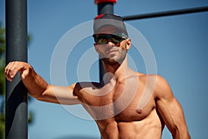 a man thinks about his body and health portrait of a sporty physique . sports stadium in the Park. short hair, beard