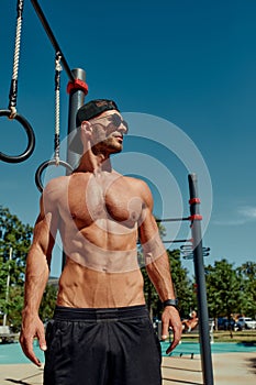 a man thinks about his body and health portrait of a sporty physique . sports stadium in the Park. short hair, beard