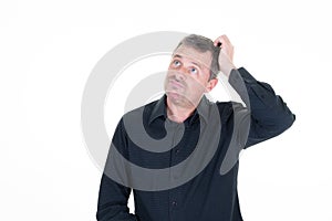 Man thinks looking up and hand behind head