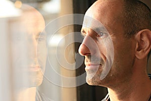 Man in thought with window reflection