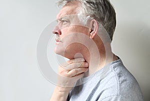 Man with throat pain