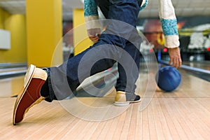 Man throw ball at bowling lane, cropped image