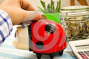 Man Is Throwing Coin Into money box