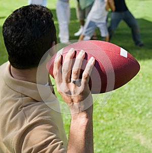 Man Throwing Football to Friends