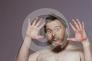 Man throwing his hands up in the hair shocked