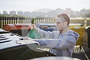 Man throwing rubbish to garbage can