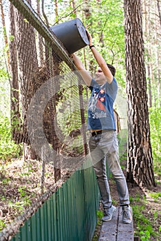 A man throws old leaves in the garden