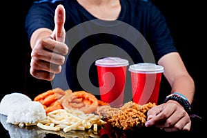 Man thumbs up in front of junk fast food package