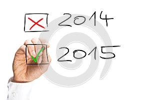 Man ticking the start of the 2015 New Year