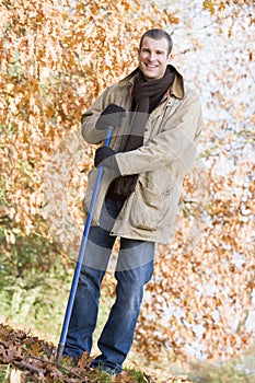 Man tidying autumn leaves photo