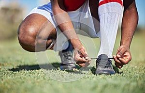 Man tie football shoes lace on soccer field, athlete ready for sports training in Portugal and exercise on grass stadium