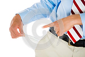 Man with tie, khakis, dress shirt, and belt, pulling out empty pocket