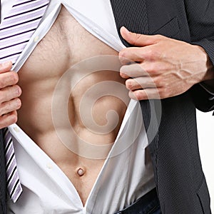 Man in tie rip clothes off torso showing abs.