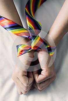 Man tied up with a rainbow necktie