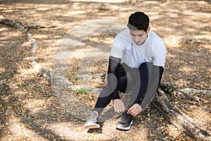 Man tied up shoes on stairs after running exercise in garden