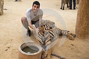 Man in Tiger temple in Thailand