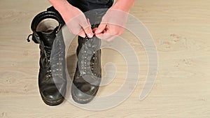 Man tighten military boots