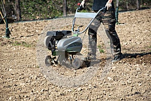 Man tilling or hoeing soil for planting