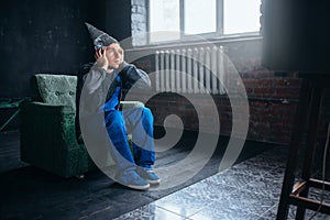 Man in tinfoil cap watch TV, telepathy phobia