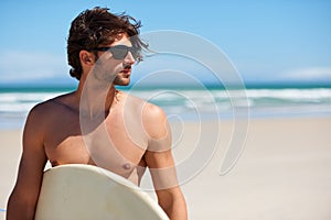 Man tinking, surf and travel with sunglasses by the beach and sea for fitness and water sport with mockup space