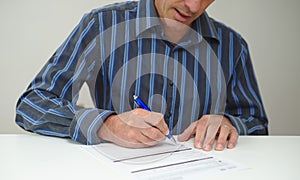 Man about to sign paperwork document