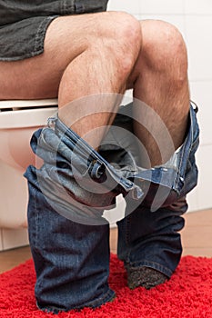 Man on the toilet is suffering about congestion photo