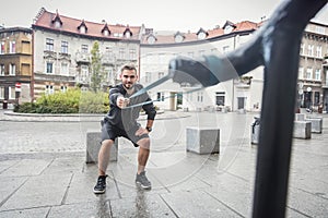 Man toning his body in an outdoor city training.