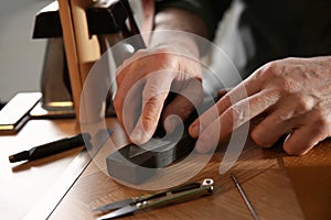 Man with tools for leather working
