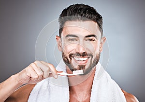 Man, toothbrush and portrait smile for dental care, hygiene or skincare against a gray studio background. Happy male