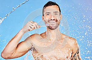 Man, toothbrush and smile for dental care, hygiene and cosmetics against an aqua blue studio background. Portrait of