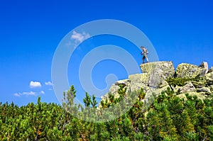 Man on top of a boulder