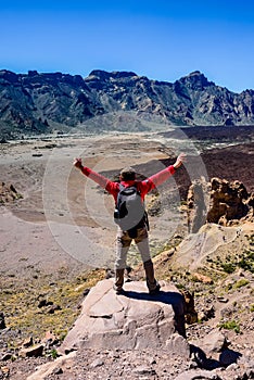 Man at the top of the Mirador de la Ruleta in Teide park on the island of Tenerife photo