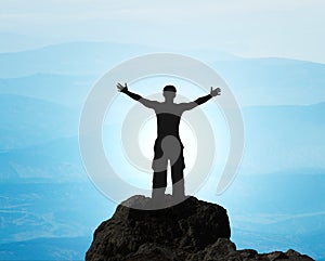 Man on top of mountain.