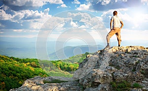 Man on top of mountain.