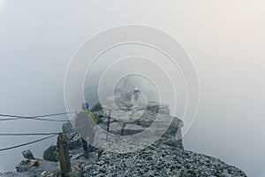 man of the top of the mountain in the fog photo