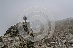 Man on top of mountain photo