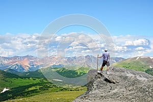 Man on top of the mountain looking at beautiful view.