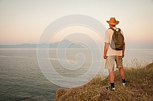 Man on the top of the mountain in the sunset