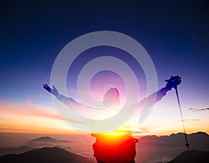 Man on the top of mountain watching sunset