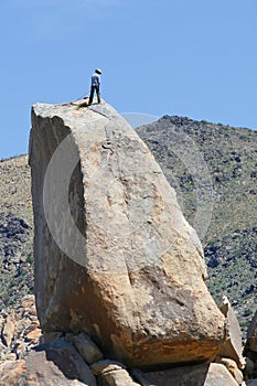 Man at the top of a rock.