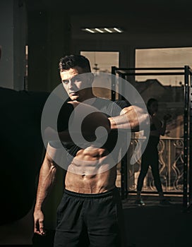 Man with torso, muscular macho and his reflexion in mirror background. Sportsman, athlete with muscles looks attractive
